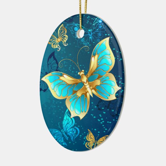 青い背景に浮かぶ金色の蝶 セラミックオーナメント (左)