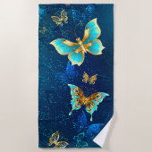 青い背景に浮かぶ金色の蝶 ビーチタオル (正面)