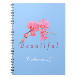 青い背景に美しいピンクの蘭の花。 ノートブック