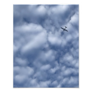 青い雲の多い空を飛ぶ小型飛行機の写真プリント フォトプリント           