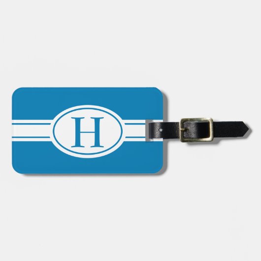 青にモノグラムを施したホワイトバンドと楕円形のシールド ラゲッジタグ (正面横)
