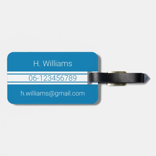 青にモノグラムを施したホワイトバンドと楕円形のシールド ラゲッジタグ (裏面横)