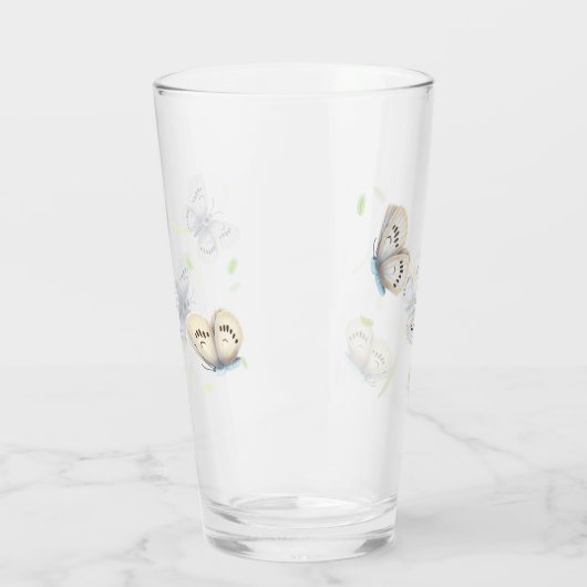 飛行かわいらし中の青とクリームの蝶 タンブラーグラス (左)