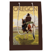 馬の背のヴィンテージ旅行ポスターのカウボーイ ミディアムペーパーバッグ (正面)