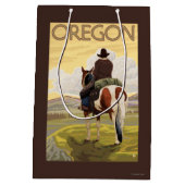 馬の背のヴィンテージ旅行ポスターのカウボーイ ミディアムペーパーバッグ (裏面)