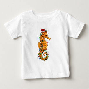 魔法のようなサンタの帽子をかぶったタツノオトシゴ ベビーTシャツ