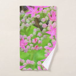 鮮やかなピンクの多肉植物セダムと緑の肉厚な葉 ハンドタオル
