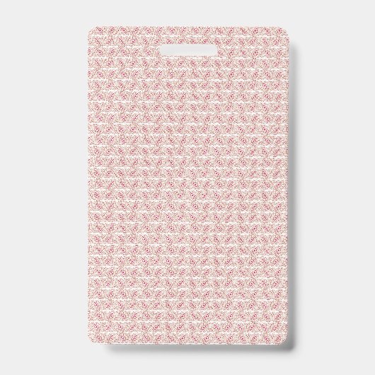 鮮やかな赤とピンクの織物が、柄の入ったラグの上に敷かれている バッジ (正面)