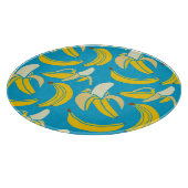 黄色いバナナ、青い背景パターン カッティングボード (角)