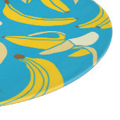 黄色いバナナ、青い背景パターン カッティングボード (角)