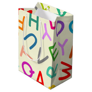 黄色の背景にアルファベットの文字がプリントされた入学シーズンのギフトバッグ ミディアムペーパーバッグ
