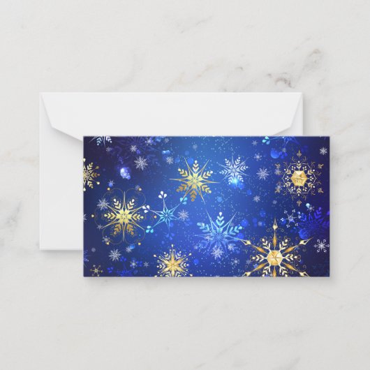 黄金の雪の結晶が付いた青いクリスマス背景 ノートカード (正面)