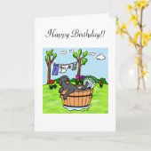 黒いラブラドールの子犬のプールの漫画 カード (黄色い花)