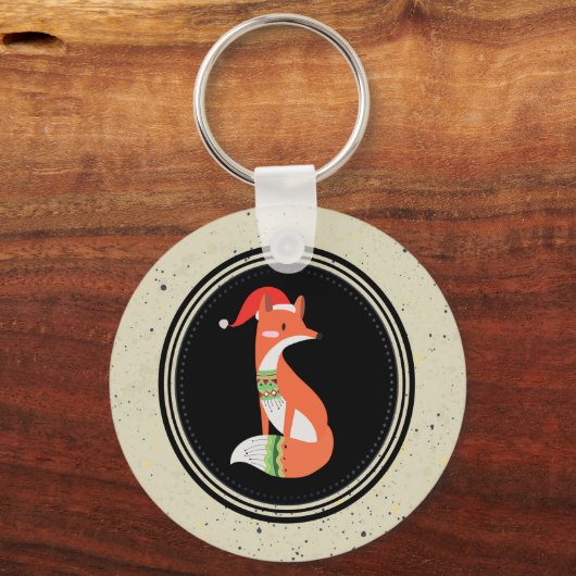 黒い円の中のクリスマスハットのかわいいキツネ キーホルダー (正面)