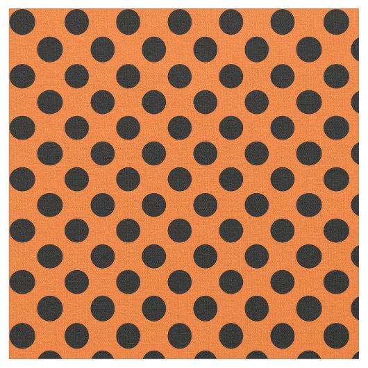 黒い水玉模様の生地を持つオレンジ ファブリック (クローズアップ)