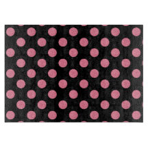 黒い渦巻形の背景にピンクの水玉模様