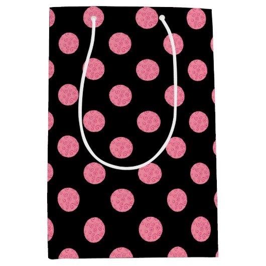 黒い渦巻形の背景にピンクの水玉模様 ミディアムペーパーバッグ (正面)