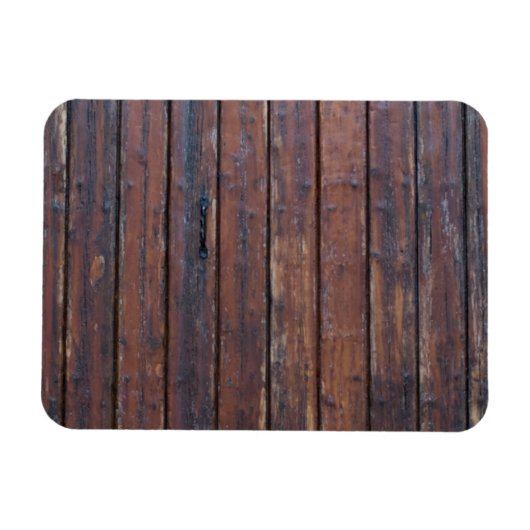 黒い鉄の支えを持つ古い茶色の木製ドア マグネット (横)