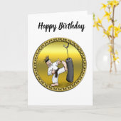 黒帯空手の男が黒い練習バッグを蹴る カード (黄色い花)