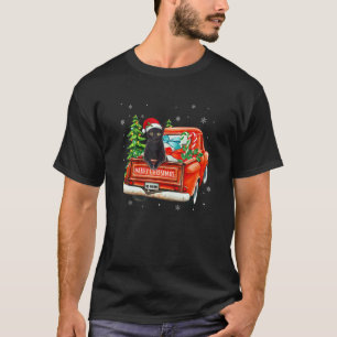 黒猫が赤いラックに乗るクリスマスパジャマの猫のXmas Tシャツ