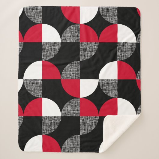 黒、赤、白の幾何学模様。 シェルパブランケット (正面)