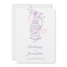 2羽のピンクの鳥が鳥かごのハート結婚を開く