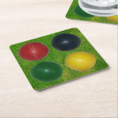 4つのクロケボール、4つの色、草の背景 スクエアペーパーコースター (アングル)
