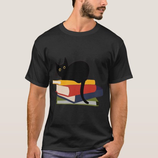 A black cat sits on top of a stack of five books. tシャツ (正面)