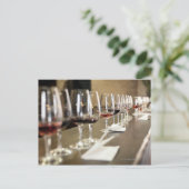 A long row of wine glasses set up so a large ポストカード (スタンド正面)