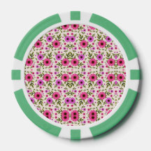 A poker chip with a floral pattern in pink 
