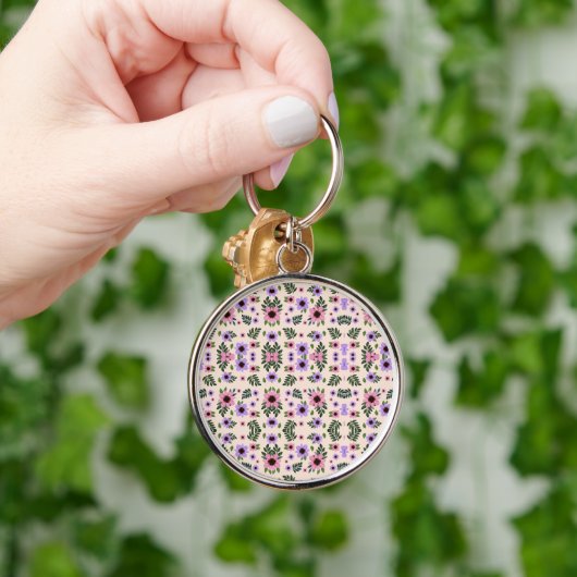 A round keychain featuring a vibrant floral  キーホルダー (手)