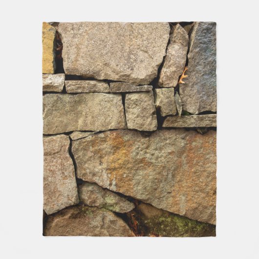 A stone wall made of cobblestones background textu フリースブランケット (正面)