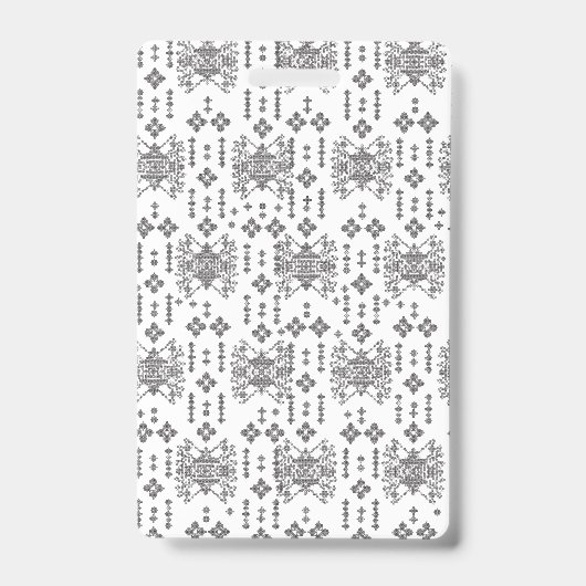 A symmetrical monochrome design featuring intricat バッジ (正面)