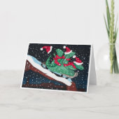A whimsical holiday card with sledding dinosaurs カード (正面)