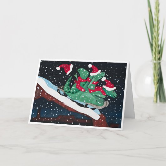 A whimsical holiday card with sledding dinosaurs カード (正面)