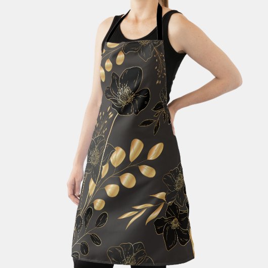 A woman wearing a black apron with elegant gold  エプロン (インサイチュ)