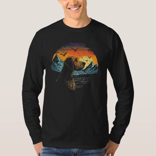 Airedale Terrier Dog and Sun Rising Over Mountains Tシャツ (正面)