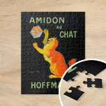 Amidon Au Chat | Leonetto Cappiello ジグソーパズル<br><div class="desc">Amidon Au Chat (1903) | Leonetto Cappiello’s vintage advertising poster Amidon Au Chat for Hoffman features a whimsical orange cat playfully interacting with a box of starch, set against a striking black background. The vibrant orange of the cat and the bold typography create a high-contrast design that is both eye-catching...</div>