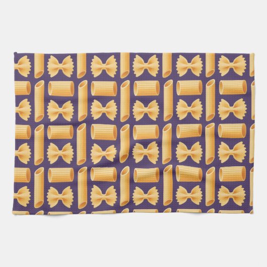 Array of various pasta shapes on a purple キッチンタオル (横)
