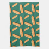 Baguette bread pattern on a green background キッチンタオル (縦)