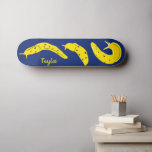 Banana Slugs Yellow and Royal Blue Personalized スケートボード<br><div class="desc">Create a personalized gift that's perfect for anyone who loves creepy crawly creatures. This skateboard features illustrations of banana slugs in a bright and cheery yellow set against a royal blue background. There's a spot to add a name in matching yellow lettering.</div>