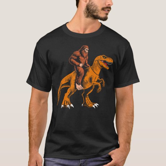 Bigfoot riding dinosaur kids sasquatch riding t re tシャツ (正面)