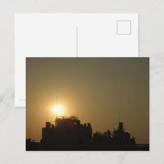 Black against the golden glow of the setting sun. ポストカード