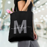 Black Trendy Modern Script Name Monogram トートバッグ<br><div class="desc">Personalized Elegant Black Trendy Modern Script Name Monogram Tote Bag. Add a touch of sophistication to your everyday style with this chic tote bag. Featuring a sleek gray initial centered on a crisp black background, with a clean and modern design on both sides, this tote combines elegance with practicality. Perfect...</div>
