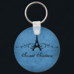 Blue Vintage French Flourish Sweet 16 Keychain キーホルダー<br><div class="desc">Grungy yet elegant Vintage French Flourish Sweet Sixteen Keychain in dark blue featuring an Eiffel Tower design embellished with chic swirls and dots and a faux paper textured background. This unique Parisian themed Sweet 16 keychain would be perfect for a french inspired party favor. Easy to customize, simply add the...</div>