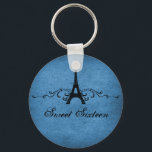 Blue Vintage French Flourish Sweet 16 Keychain キーホルダー<br><div class="desc">Grungy yet elegant Vintage French Flourish Sweet Sixteen Keychain in dark blue featuring an Eiffel Tower design embellished with chic swirls and dots and a faux paper textured background. This unique Parisian themed Sweet 16 keychain would be perfect for a french inspired party favor. Easy to customize, simply add the...</div>