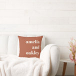 Bold Minimalist Terracotta Retro Custom Wedding クッション<br><div class="desc">This personalized pillow features bold serif typography set against a terracotta rust background for a modern yet romantic wedding look. The clean layout highlights the couple’s names and wedding date, creating a meaningful piece of decor that feels personal and timeless. Perfect for adding a special touch to a sofa, chair,...</div>