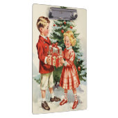 Boy and girl giving each other Christmas presents クリップボード (右)