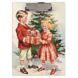 Boy and girl giving each other Christmas presents クリップボード