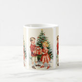 Boy and girl giving each other Christmas presents コーヒーマグカップ (中央)